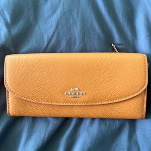 NWT tangerine colored Coach wallet